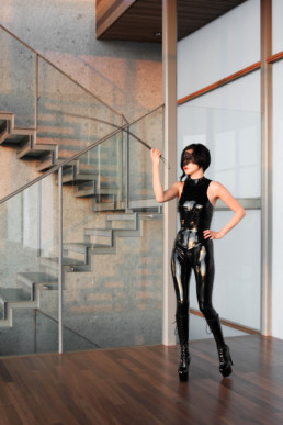 San Francisco Asian Dominatrix Yuki cracks her leather whip as she wears a latex body suit and leather boots.